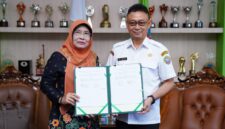 Wali Kota Pontianak Edi Rusdi Kamtono dan Rektor Universitas OSO Yarlina Yacoub memperlihatkan naskah MoU kerja sama kedua belah pihak.