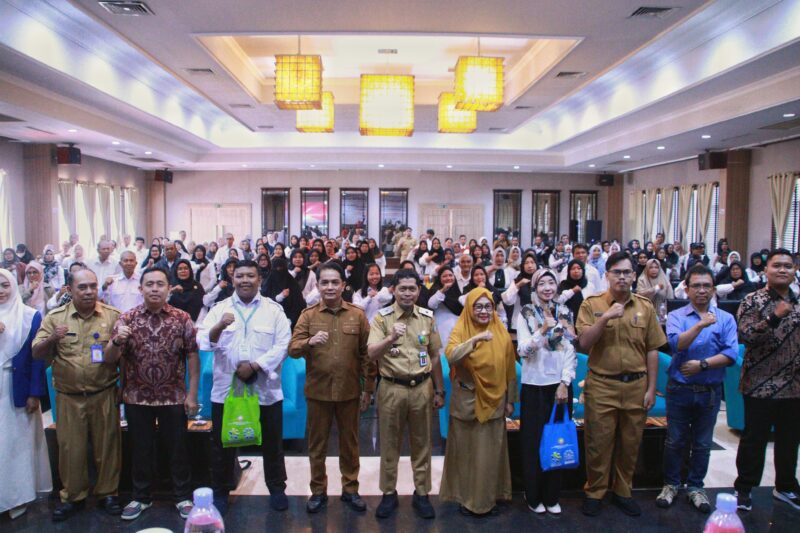 Wakil Wali Kota Pontianak Bahasan memasangkan tanda peserta secara simbolis kepada peserta pelatihan Teknologi Informasi Koperasi.